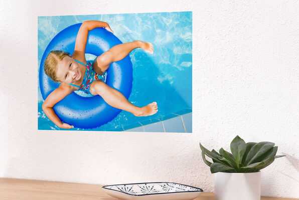 Enlarged photo print of child in a family pool